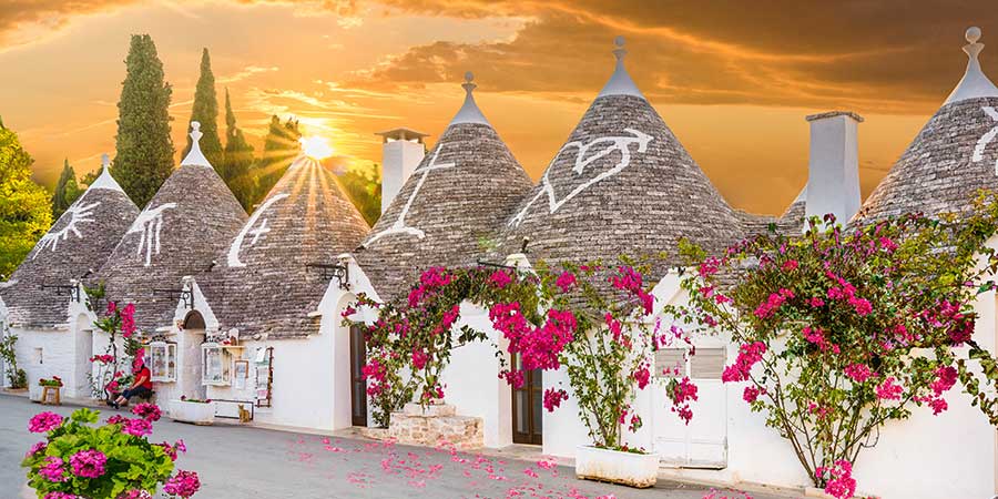 The sun sets over Alberobello